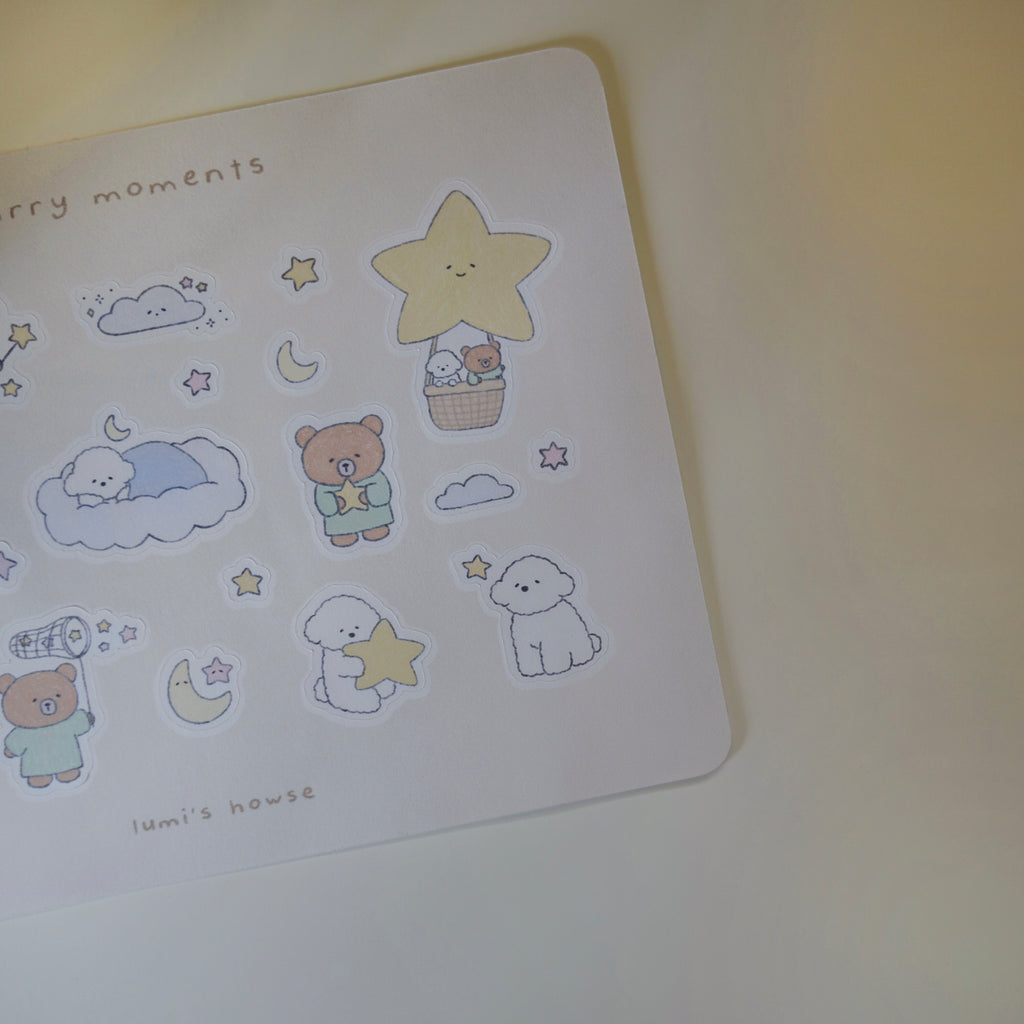 Sheet of cute illustrated stickers featuring a bear and dog, stars, and clouds on a white background.