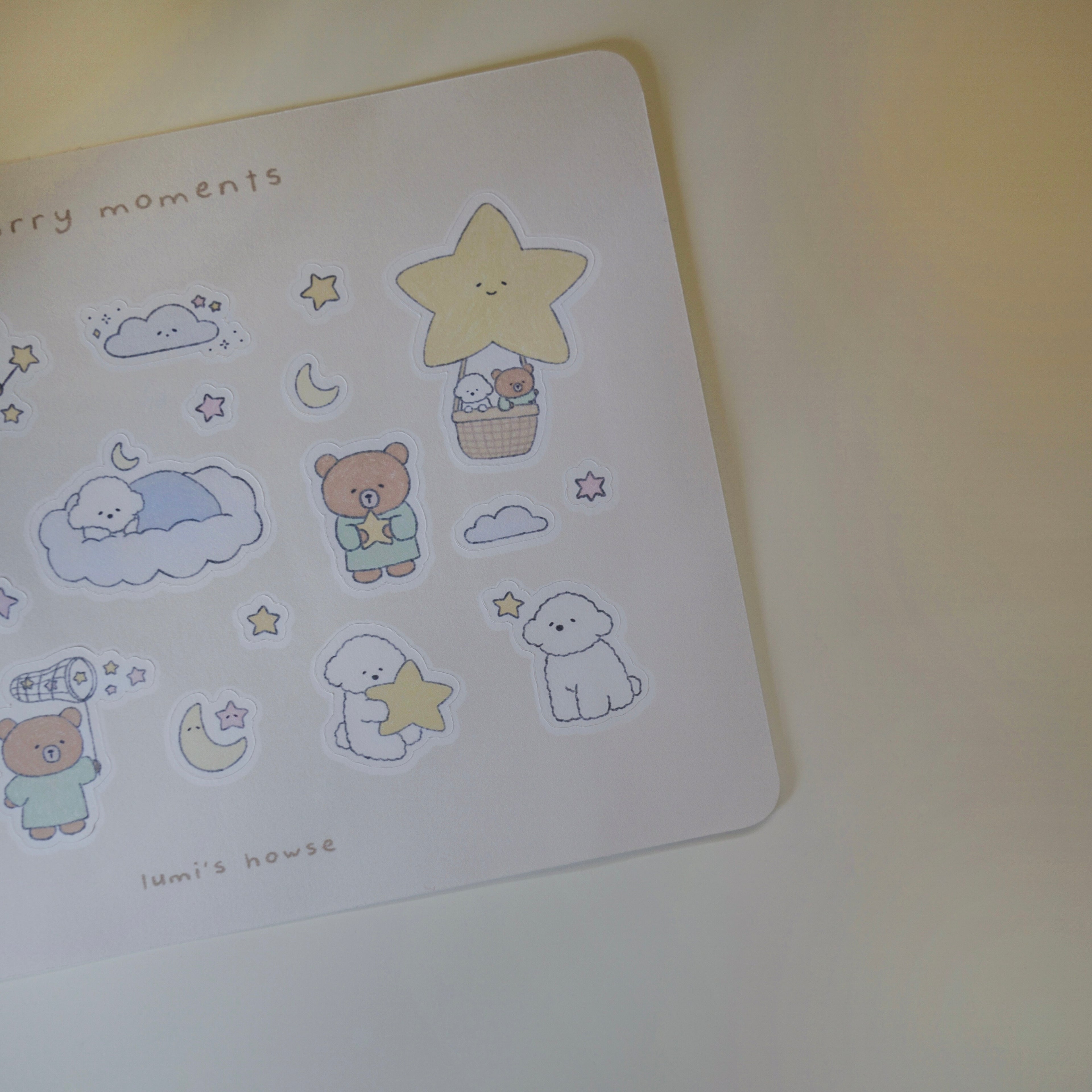 Sheet of cute illustrated stickers featuring a bear and dog, stars, and clouds on a white background.