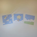 Three prints with star and cloud designs on a white surface.
