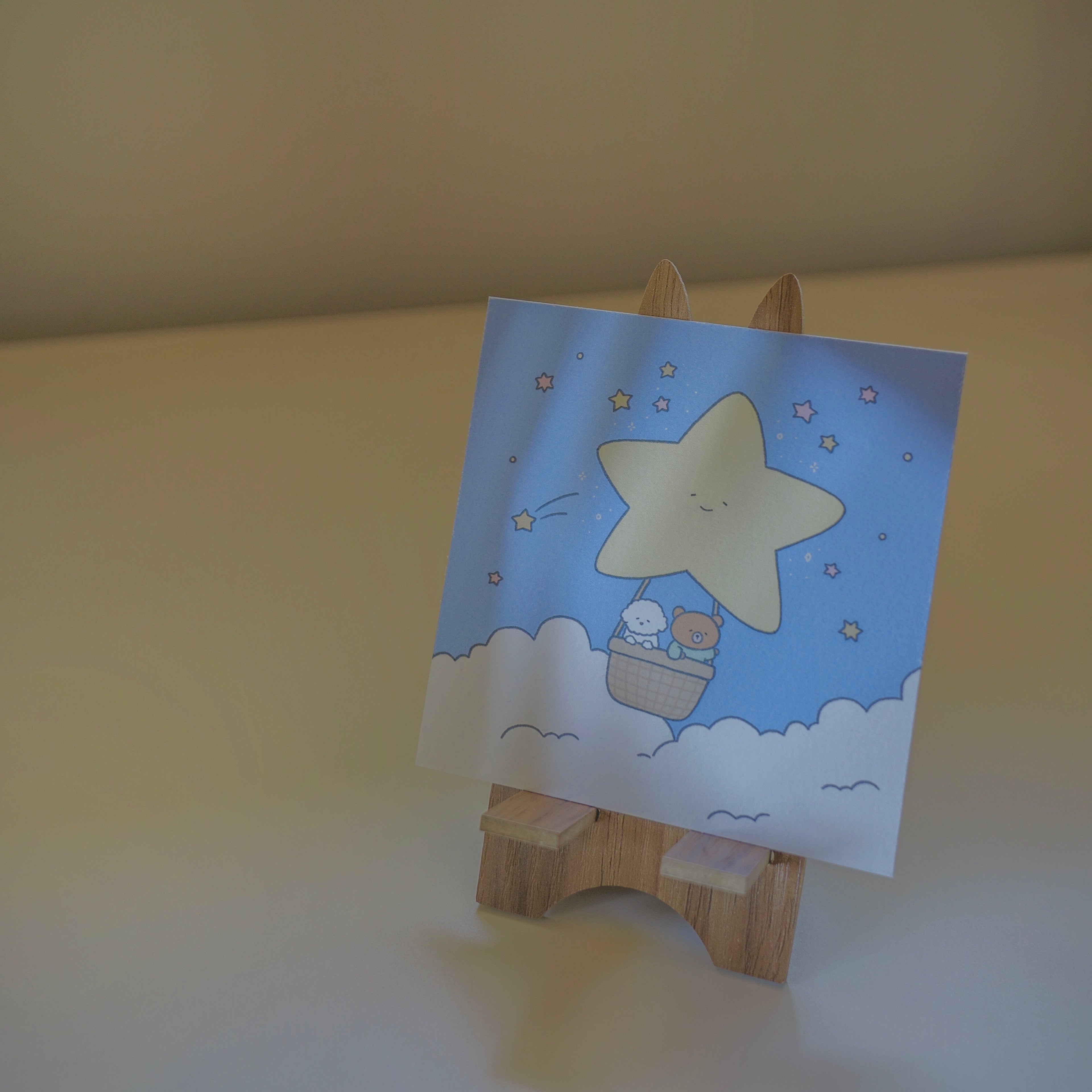 Print with a star design on a wooden stand against a plain background.