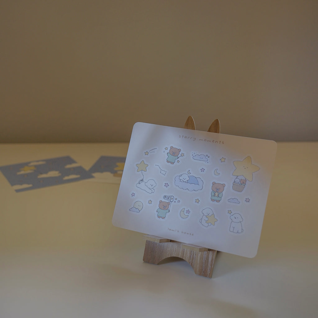 Sticker sheet with cartoon designs on a wooden stand against a plain background.