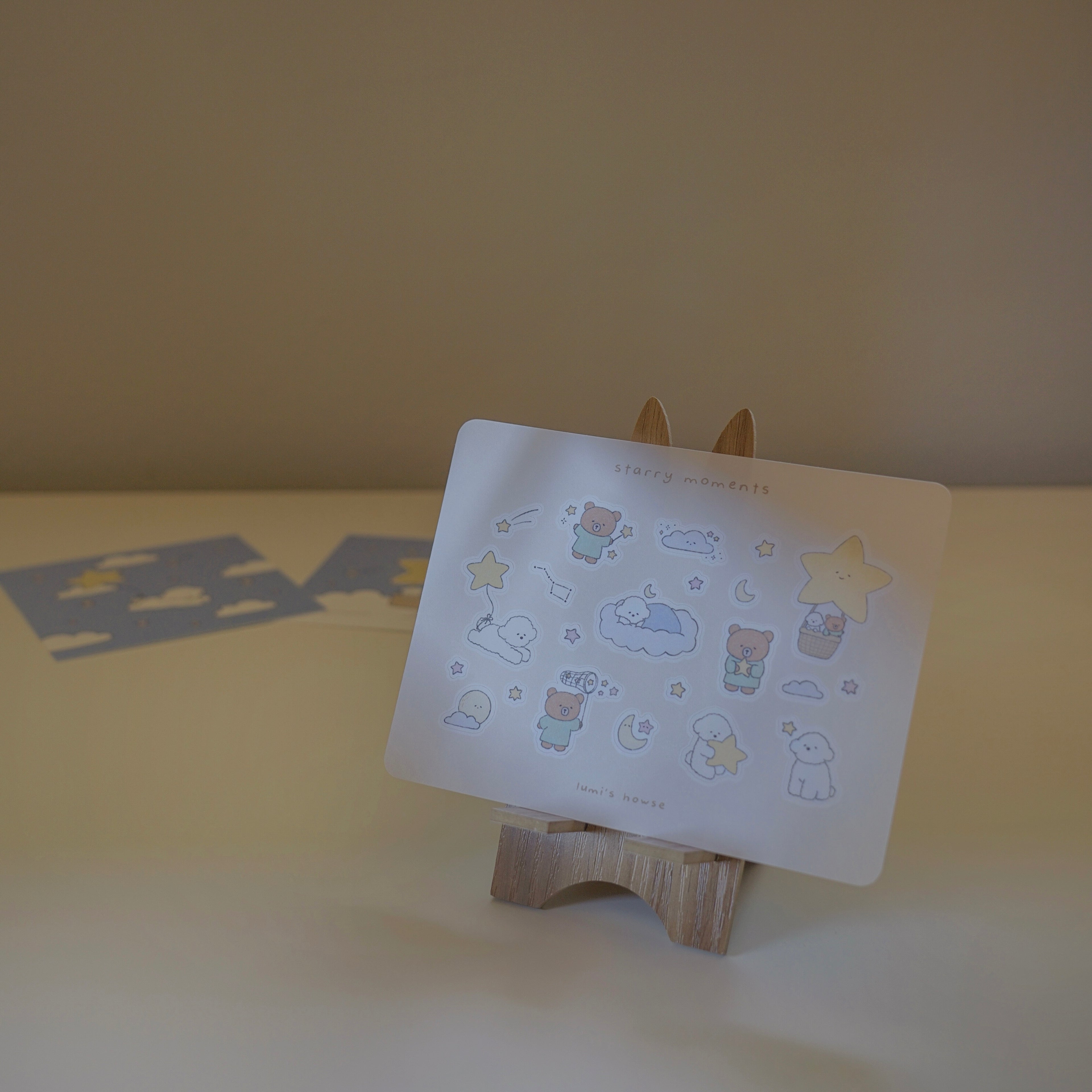 Sticker sheet with cartoon designs on a wooden stand against a plain background.