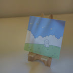 Print with a dog illustration on a wooden stand against a beige background.