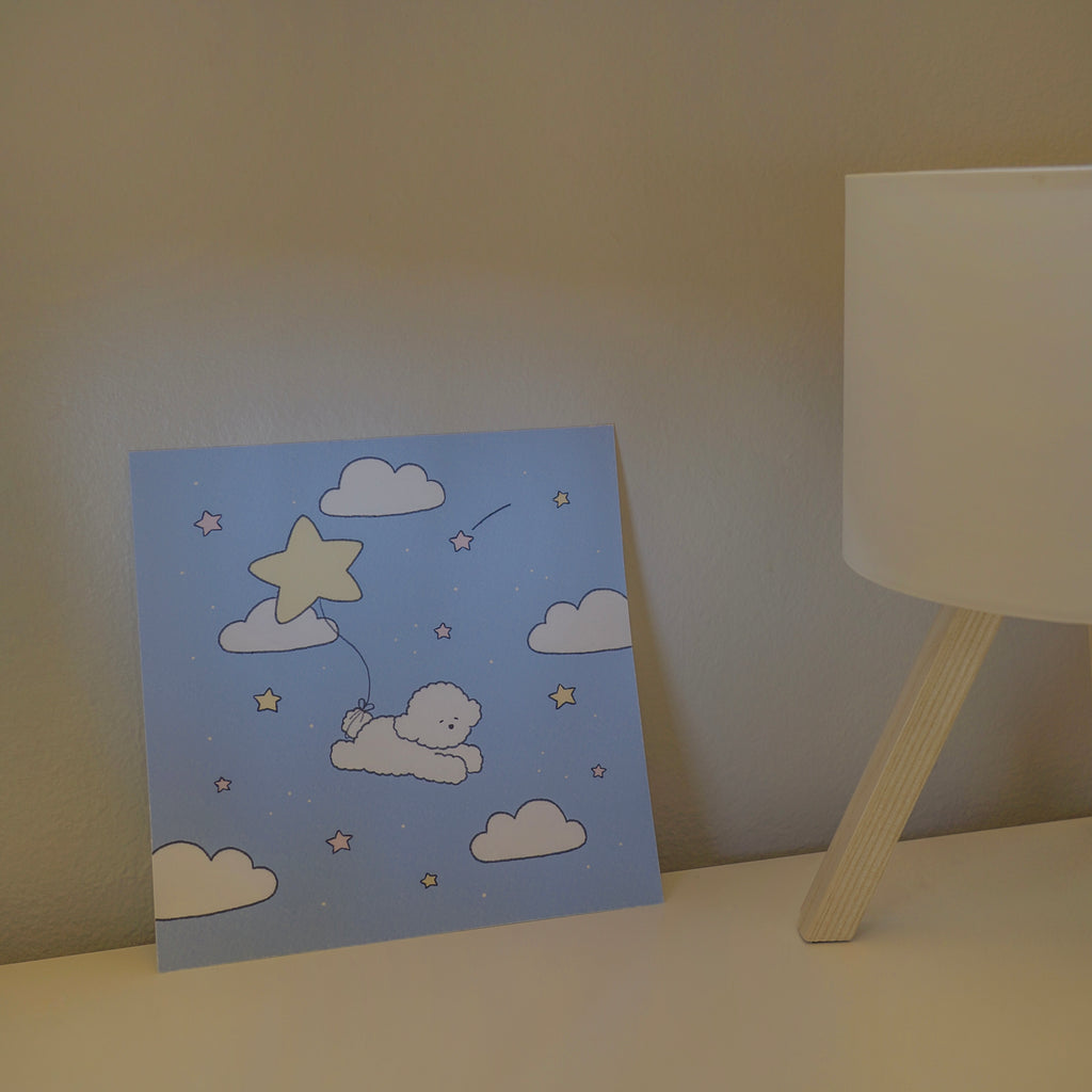Illustration of a dog with a star balloon on a blue print, placed against a neutral wall.