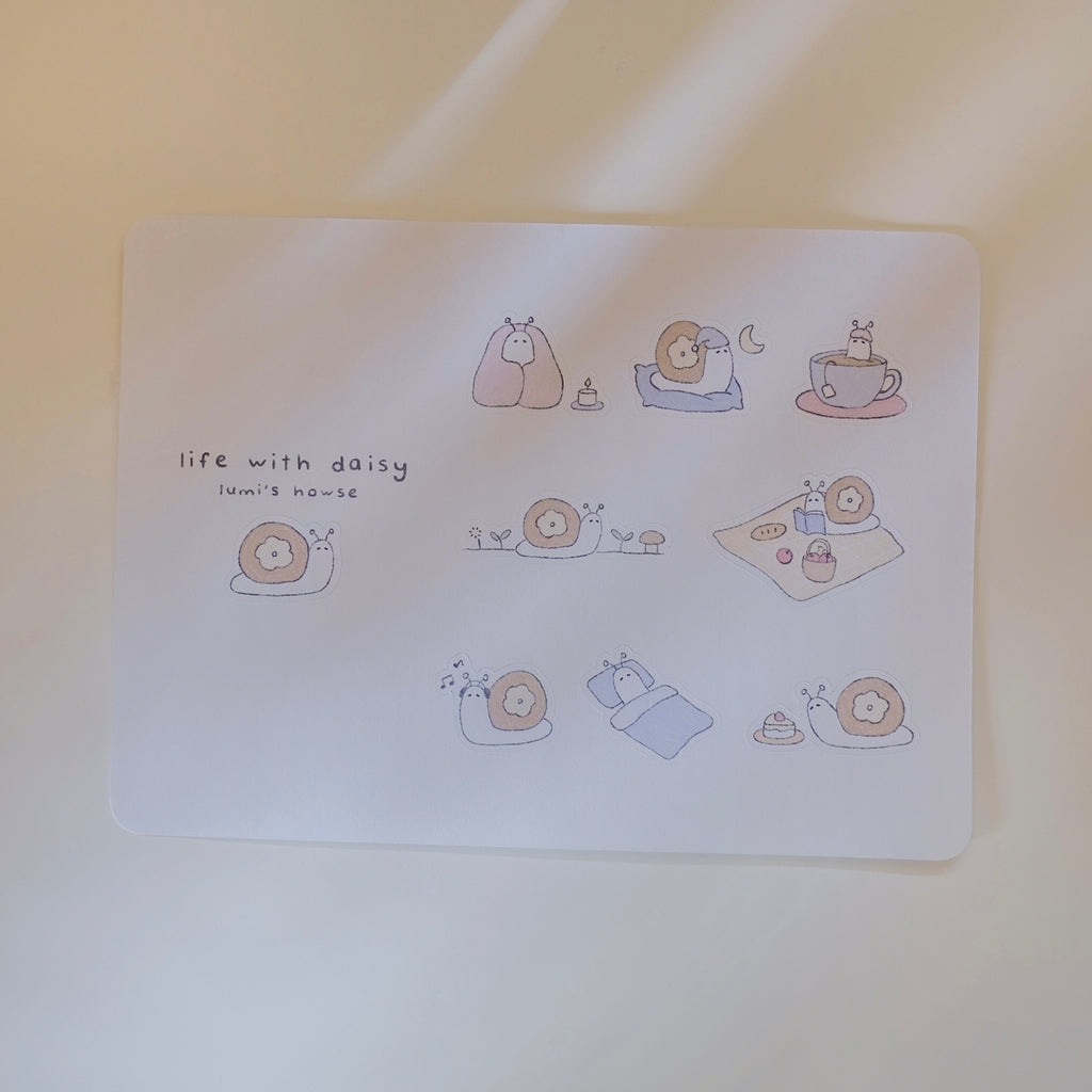 Sticker sheet with illustrations of a snail, featuring 'life with daisy' text.