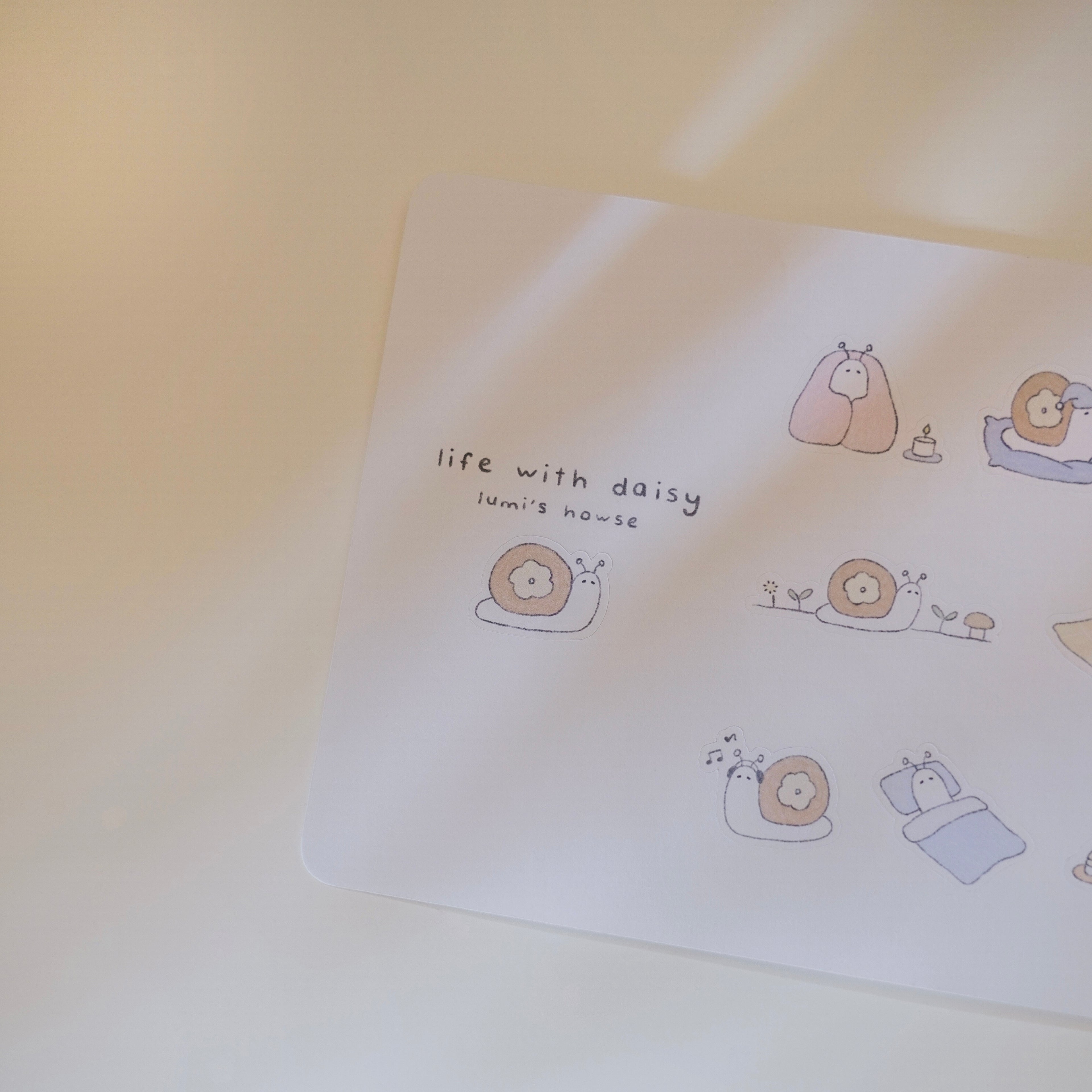 Sticker sheet with cartoon illustrations of a snail and text on a light background.