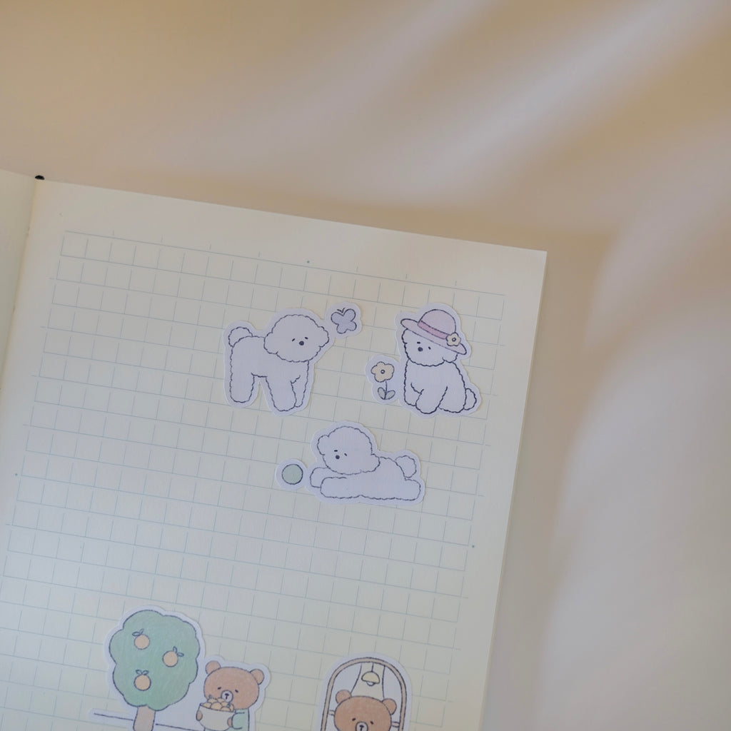 Illustrations of dogs on grid paper with a soft focus background.