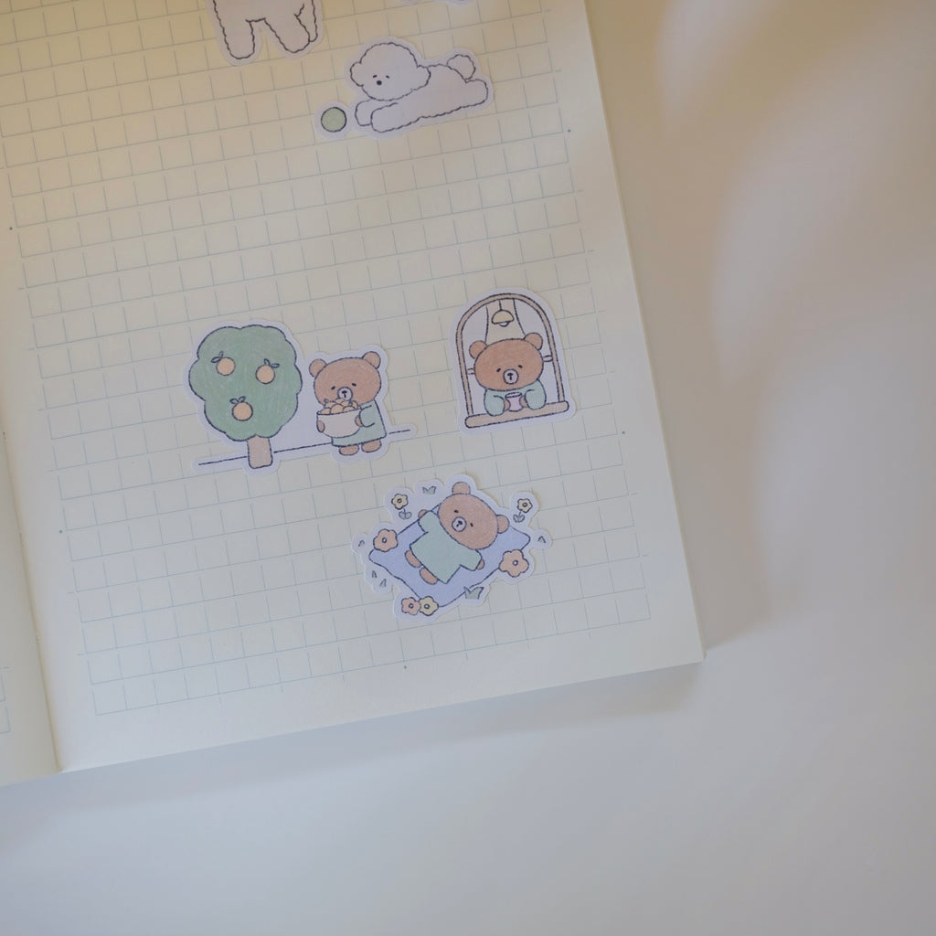 Sticker sheet with cute bear illustrations on a grid notebook page.