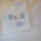 Sticker sheet with cute bear illustrations on a grid notebook page.