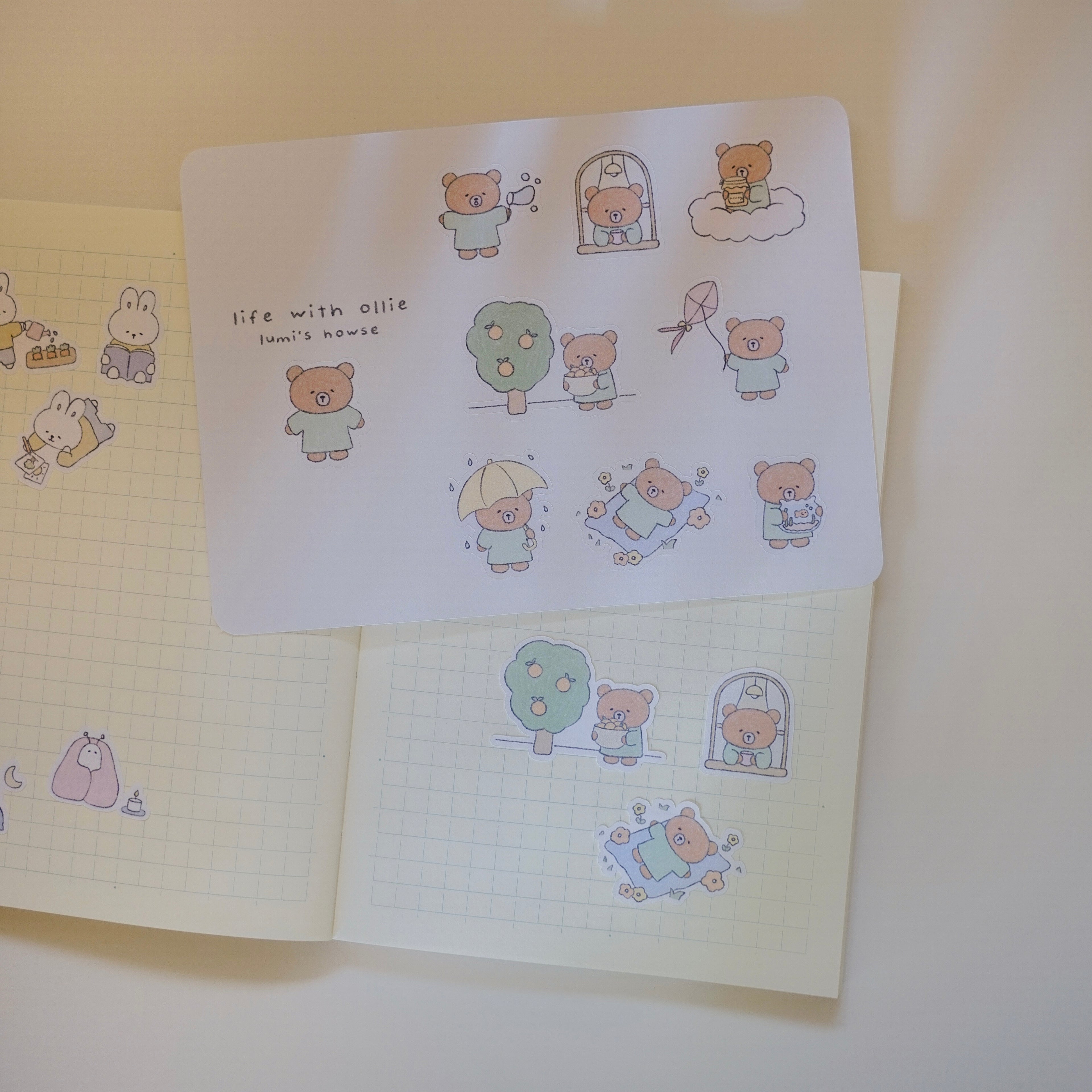 Sticker sheet with cartoon bear designs on a notebook.