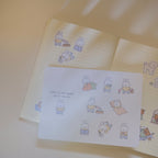 Notebook with cute bunny illustrations on a sticker sheet with a light background.