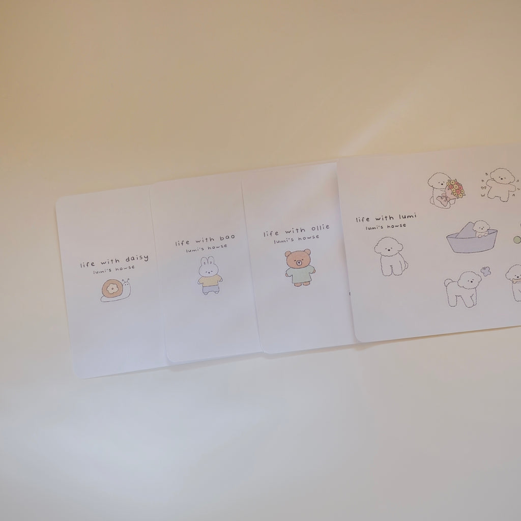 Four sticker sheets with cartoon animal characters on a white surface.