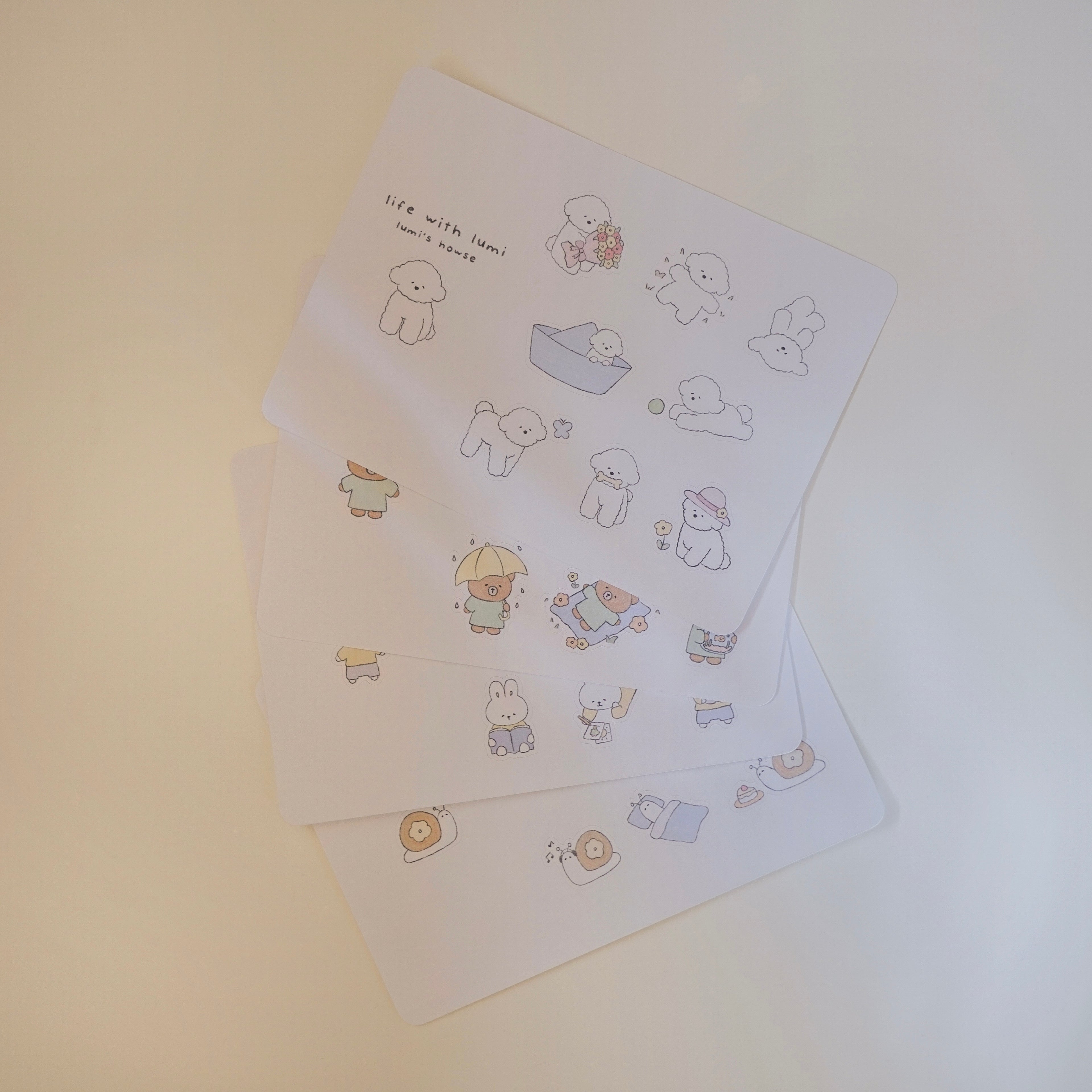 Set of illustrated sticker sheet with cute animal designs on a light background.